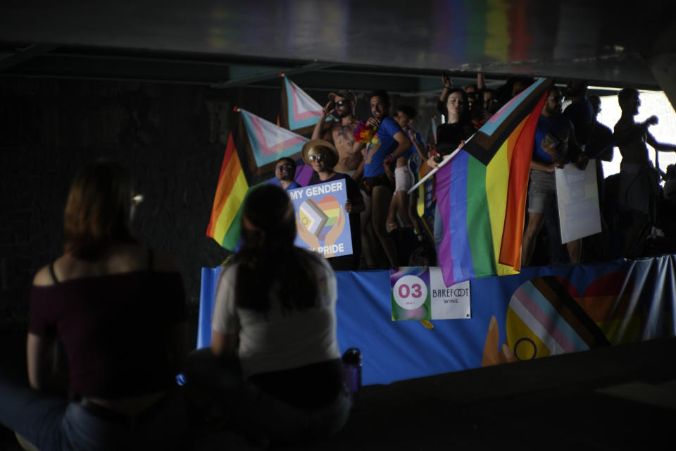 Thousands of people lined canals and bridges in the Dutch capital to watch the colorful spectacle of the Pride Canal Parade return for the 25th edition after the last two events were canceled due to the COVID-19 pandemic, in Amsterdam, Netherlands, Saturday, Aug. 6, 2022. (AP Photo/Peter Dejong)