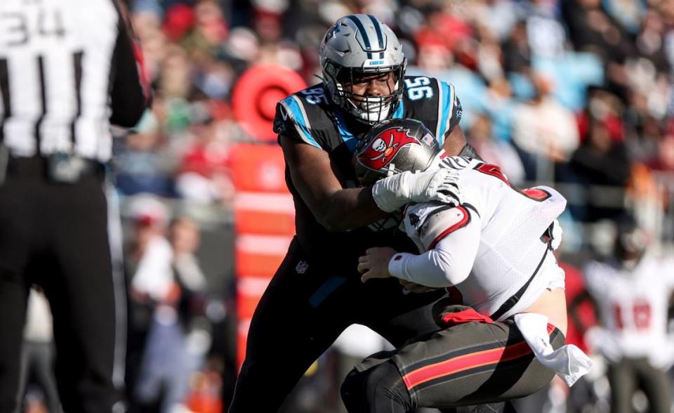 Carolina Panthers defensive tackle Derrick Brown, left, sacks Tampa Bay Buccaneers quarterback Baker Mayfield at the Bank of America Stadium in Charlotte, N.C., on Sunday, January 7, 2024.