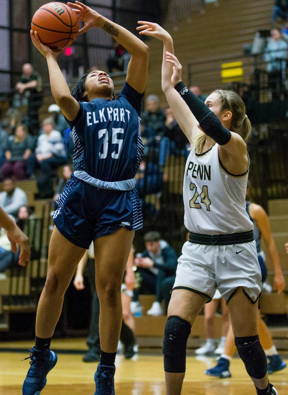 Elkhart Central's Yiesha Williams tries to shoot over Penn's Caroline Morris during the Elkhart Central at Penn girls basketball game Tuesday, Jan. 14, 2020 at Penn High School in Mishawka.