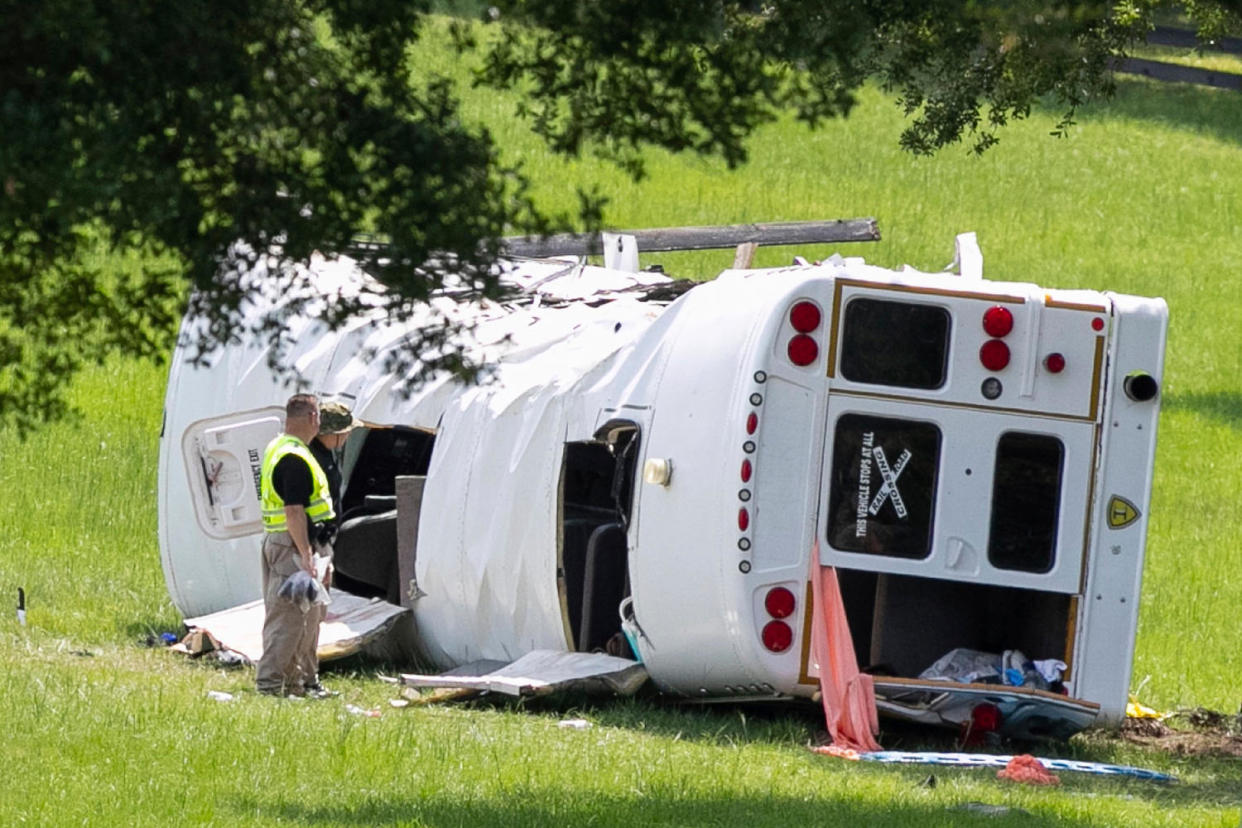 Authorities work at the scene of a deadly crash (Alan Youngblood / AP)