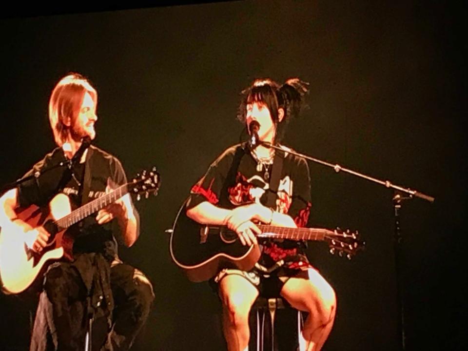 A video screen look at Billie Eilish and brother Finneas (left) during "Your Power" at PPG Paints Arena on Tuesday. Note the blood on Billie's knees after a stage move.