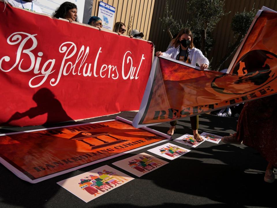 Demonstrators prepare for a Kick Big Polluters Out protest at the COP27 U.N. Climate Summit, Thursday, Nov. 10, 2022, in Sharm el-Sheikh, Egypt. (AP Photo/Peter Dejong)