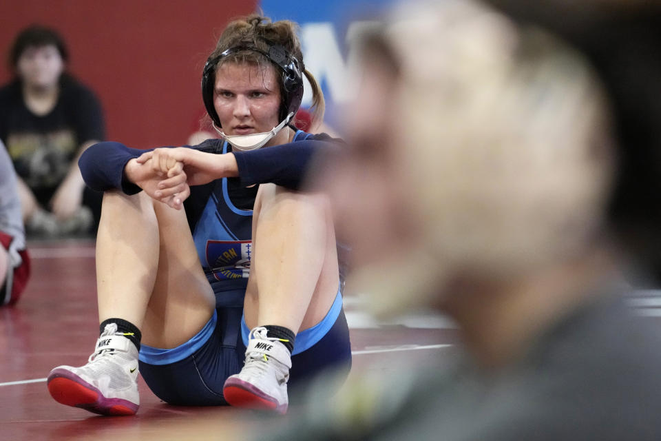 North Central women's wrestling team's Yelena Makoyed listens to head coach Joe Norton during a practice at North Central College in Naperville, Ill., Monday, March 4, 2024. The team is a national powerhouse even though the program is only a few years old and the school is D-III. (AP Photo/Nam Y. Huh)