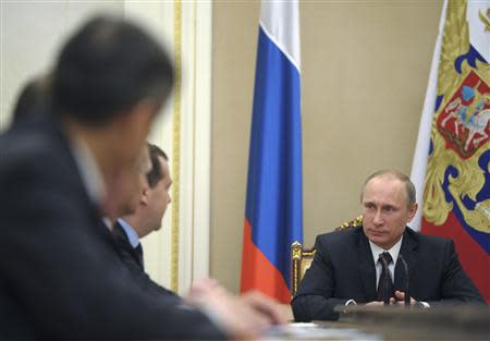 Russian President Vladimir Putin chairs a meeting of the Security Council in Moscow's Kremlin March 21, 2014. REUTERS/Alexei Druzhinin/RIA Novosti/Kremlin