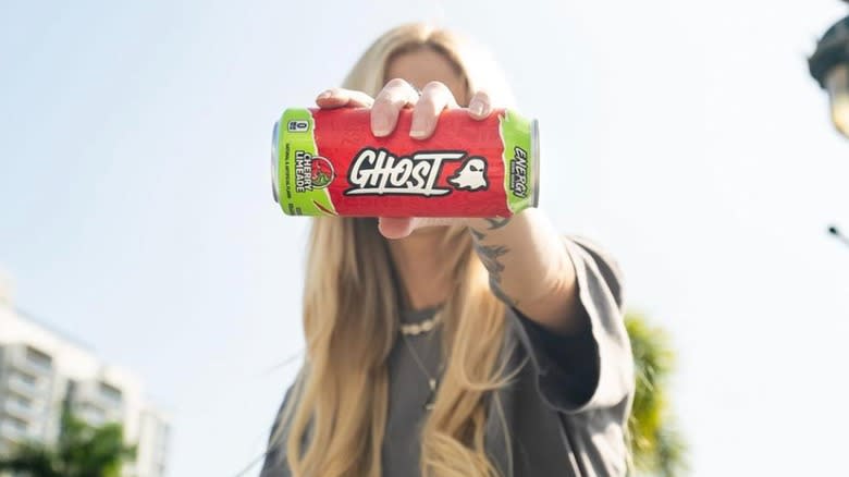 A woman holding a can of Ghost Energy drink 