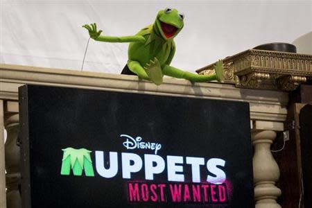 Muppet Kermit the Frog poses for photos after ringing the opening bell at the New York Stock Exchange March 17, 2014. REUTERS/Brendan McDermid