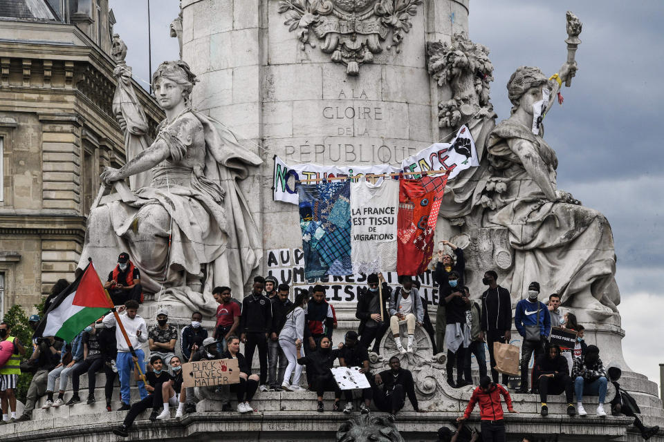 Image: Protesters stand on the statue of Marianne on Place de la Republique in Paris (Anne-Christine Poujoulat / AFP via Getty Images file)