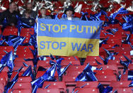 A man holds a Ukrainian flag before the World Cup 2022 qualifying play-off soccer match between Scotland and Ukraine at Hampden Park stadium in Glasgow, Scotland, Wednesday, June 1, 2022. (AP Photo/Scott Heppell)