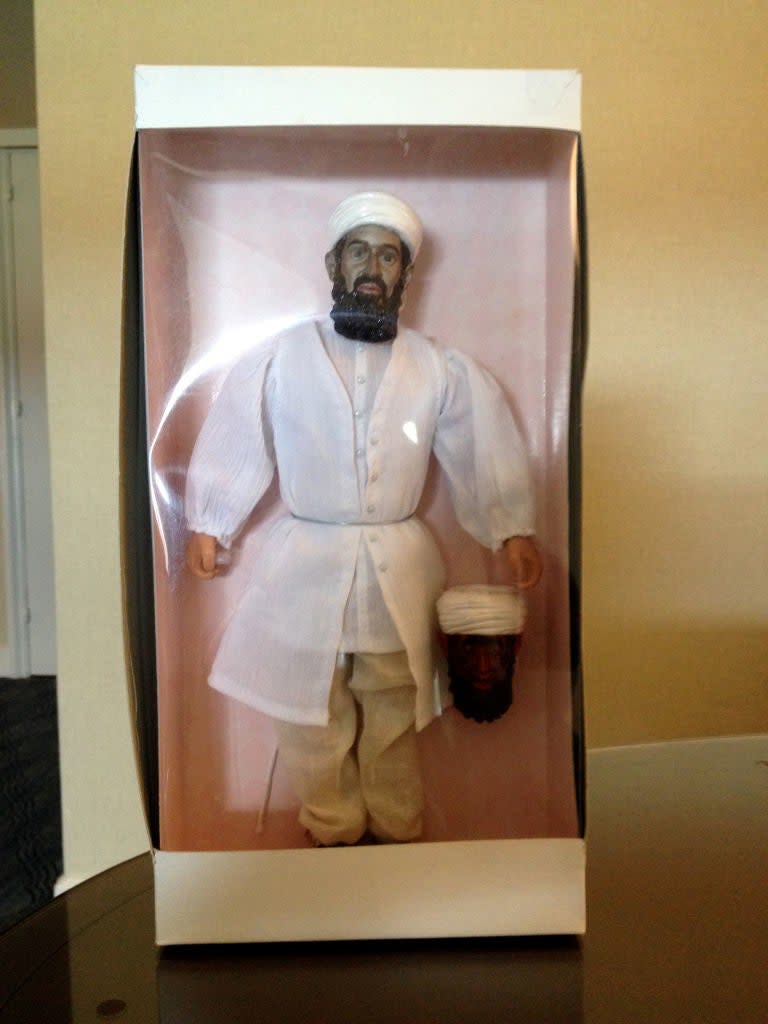 An action figure of Osama bin Laden in packaging
