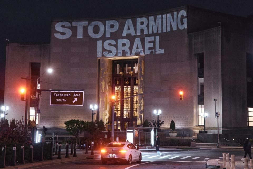 Protesters project a banner on the Brooklyn Public Library during a pro-Palestinian demonstration demanding a permanent ceasefire in Gaza (AP)