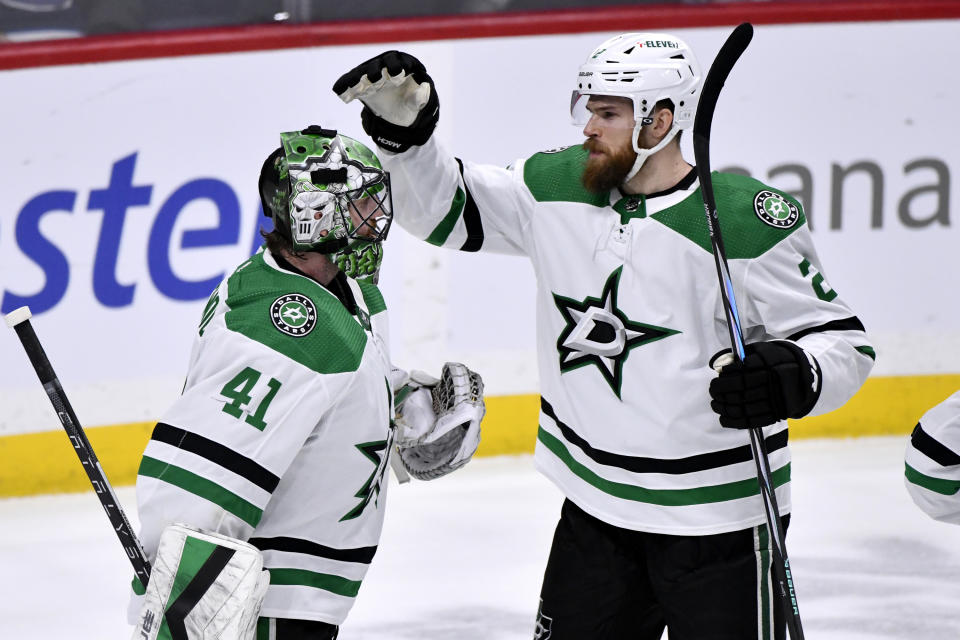 Dallas Stars' Jani Hakanpaa (2) celebrates a win over the Winnipeg Jets with goaltender Scott Wedgewood (41) during the third period of an NHL hockey match in Winnipeg, Manitoba, on Saturday, Nov. 11, 2023. (Fred Greenslade/The Canadian Press via AP)