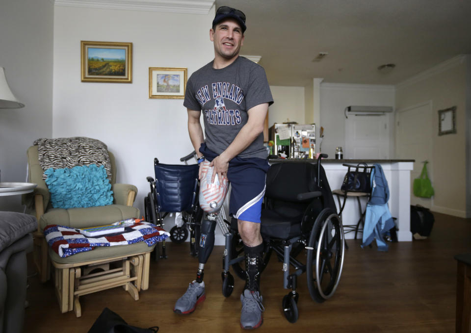 In this March 25, 2014 photo, Boston Marathon bombing survivor Marc Fucarile puts on a prosthetic leg at his home in Reading, Mass. He is adamant that he will recover and return to a full and active life; his focus is on others. He wants to be a motivational speaker and to set up a fund to help those who have suffered similar injuries, no matter the circumstances. He has been inspired by the generosity he has seen over the past year. (AP Photo/Steven Senne)