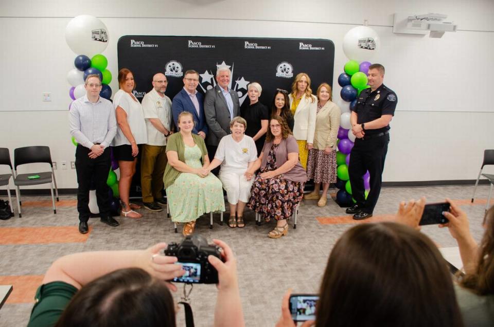 Pasco School District officials, Tri-City lawmakers and police pose for photos during a May 16 event celebrating the Richard Lenhart Act being signed into law.