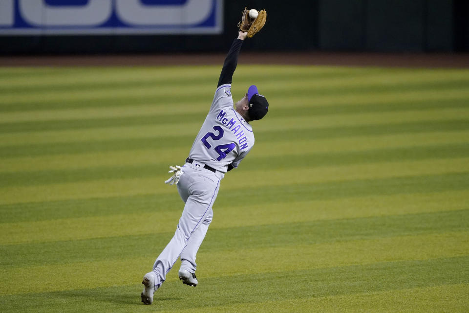 Colorado Rockies' Ryan McMahon (24) catches a fly out hit by Arizona Diamondbacks' David Peralta during the second inning of a baseball game, Saturday, Sept. 26, 2020, in Phoenix. (AP Photo/Matt York)