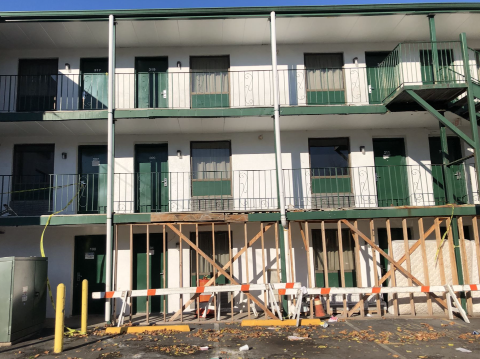 The second floor balcony of the Neshaminy Inn is propped up with wooden boards and and caution tape appears on some floors of the Route 1 hotel in Bensalem.