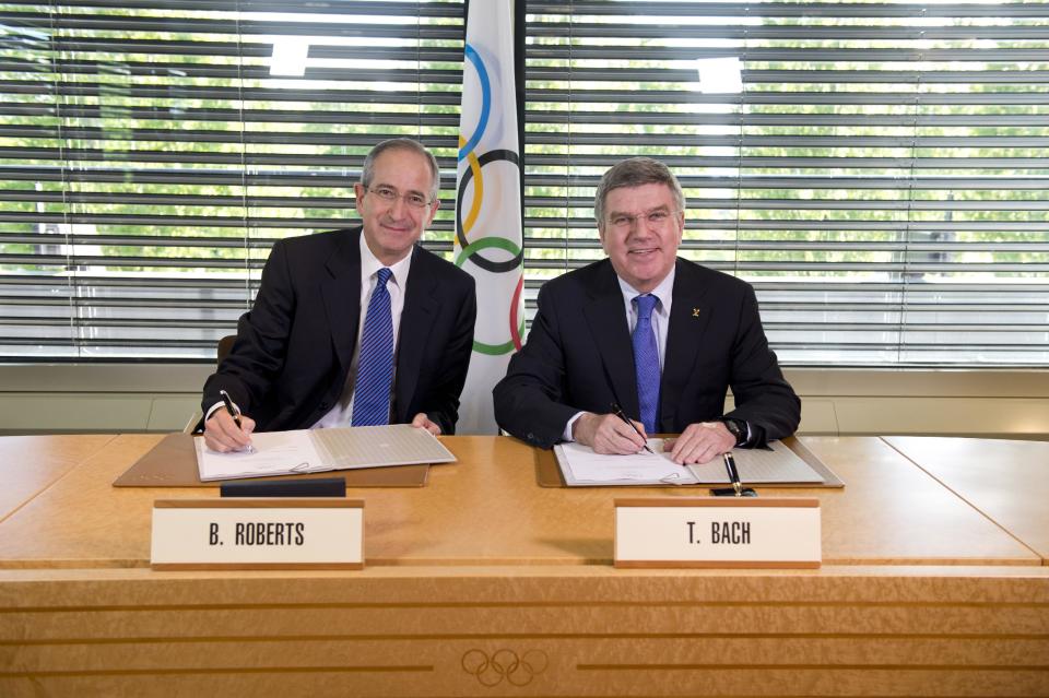 In this photo released by the International Olympic Committee (IOC), IOC President Thomas Bach, right, and Chairman and CEO of Comcast Corporation Brian L. Roberts pose for a photograph as they sign an agreement to secure the U.S. broadcast rights to the Olympics through to 2032 for NBC Universal, in Lausanne, Switzerland, Wednesday, May 7, 2014. NBC secured the U.S. broadcast rights to the Olympics through 2032 on Wednesday in a record six-games deal worth $7.75 billion. NBC already holds the rights through the 2020 Olympics in a four-games deal signed in 2011 for $4.38 billion. (AP Photo/Arnaud Meylan)