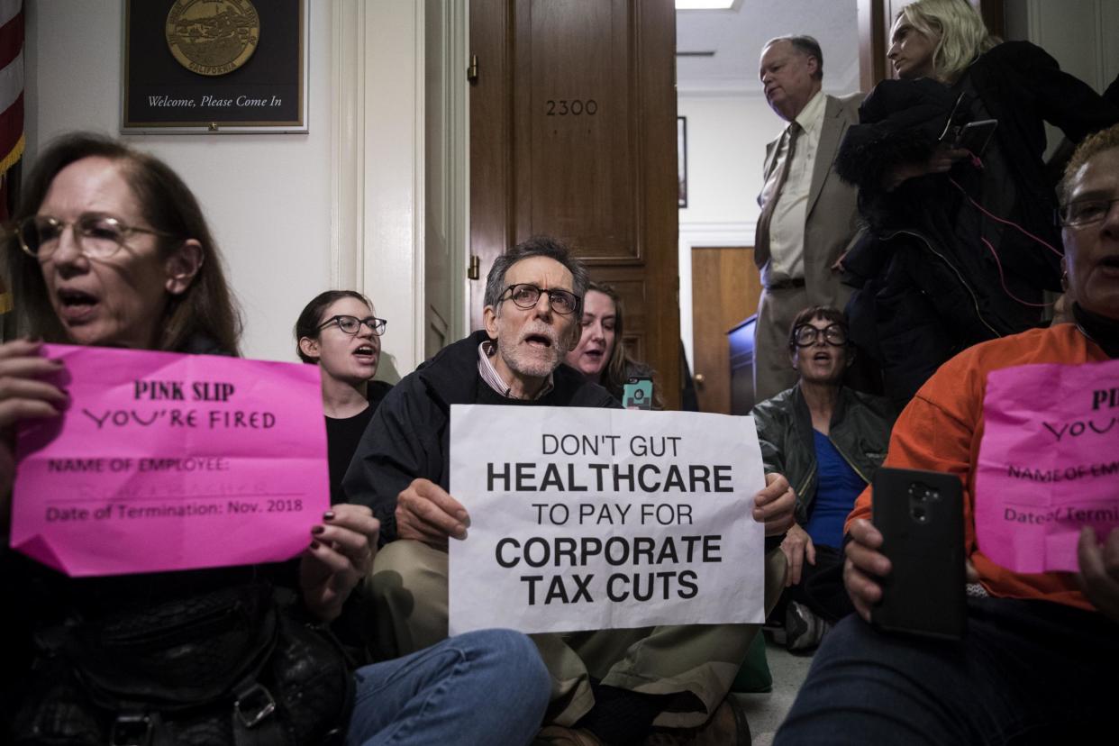 Activists stage a sit-in to protest the GOP tax reform bill outside of office of Representative Dana Rohrabacher: Drew Angerer/Getty Images