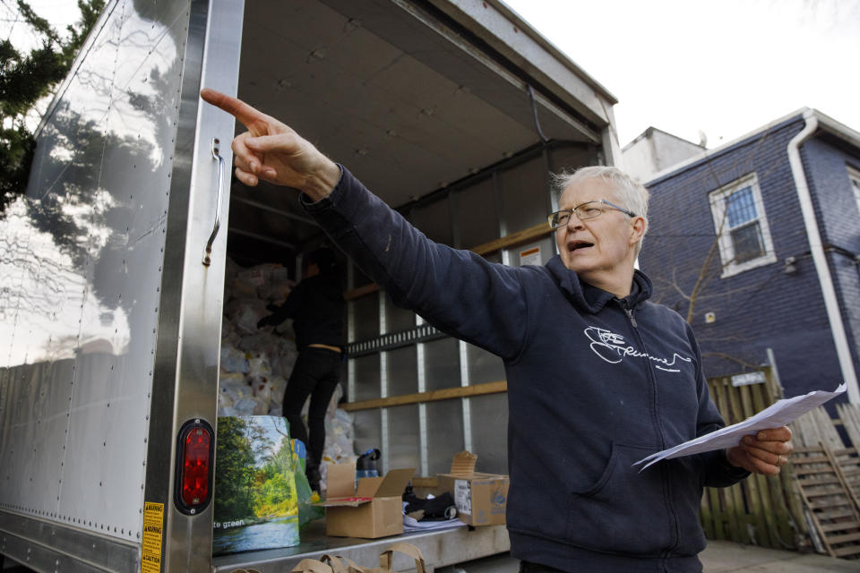 Mark Andersen, 60, co-director of the nonprofit organization, "We Are Family DC," organizes groceries and food to be brought to seniors, Saturday, March 21, 2020, in Washington. Seniors are being encouraged to stay in their homes due to the risk of the COVID-19 coronavirus. (AP Photo/Jacquelyn Martin)