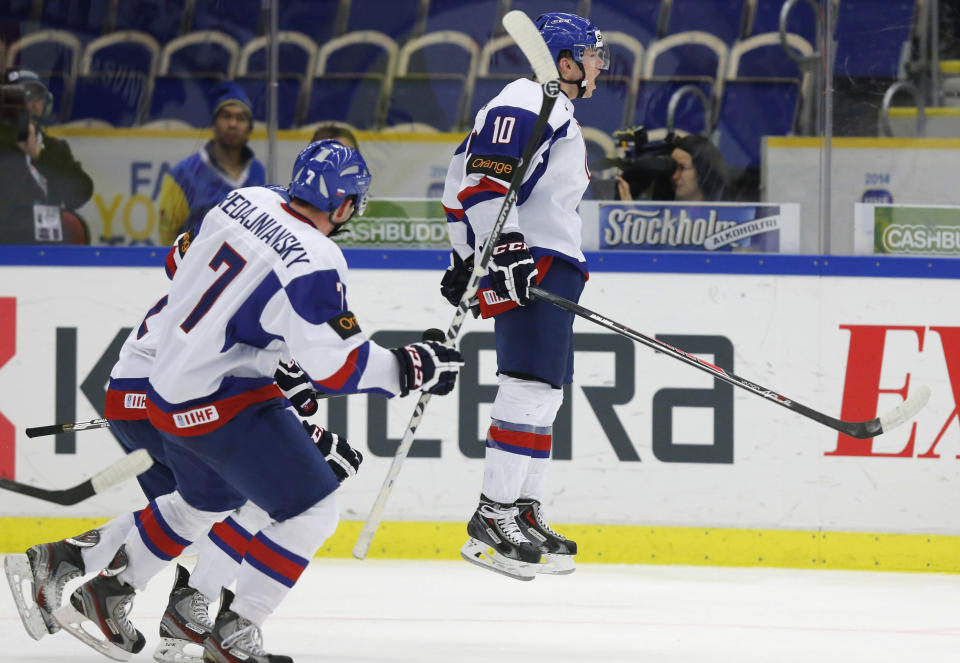 Slovakia's Martin Reway (R), Jakub Predajniansky (C) and David Griger celebrate after scoring a goal against the U.S. during the second period of their IIHF World Junior Championship ice hockey game in Malmo, Sweden, December 28, 2013. REUTERS/Alexander Demianchuk (SWEDEN - Tags: SPORT ICE HOCKEY)