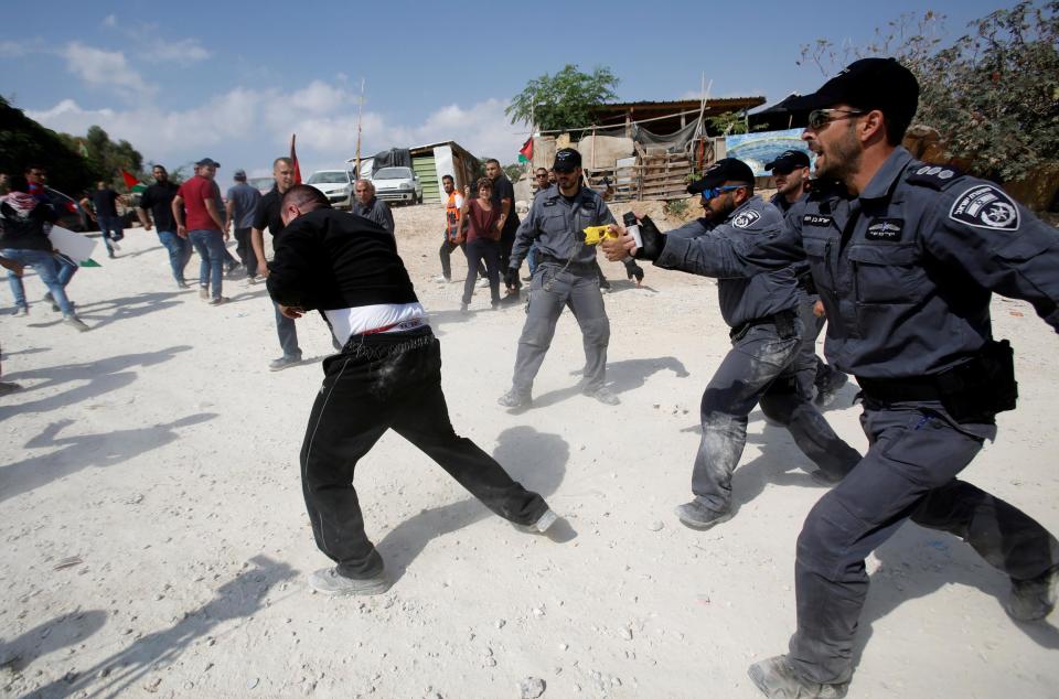 Israeli policemen disperse activists in the Palestinian Bedouin village of Khan al-Ahmar that Israel plans to demolish, in the occupied West Bank October 17, 2018: Reuters