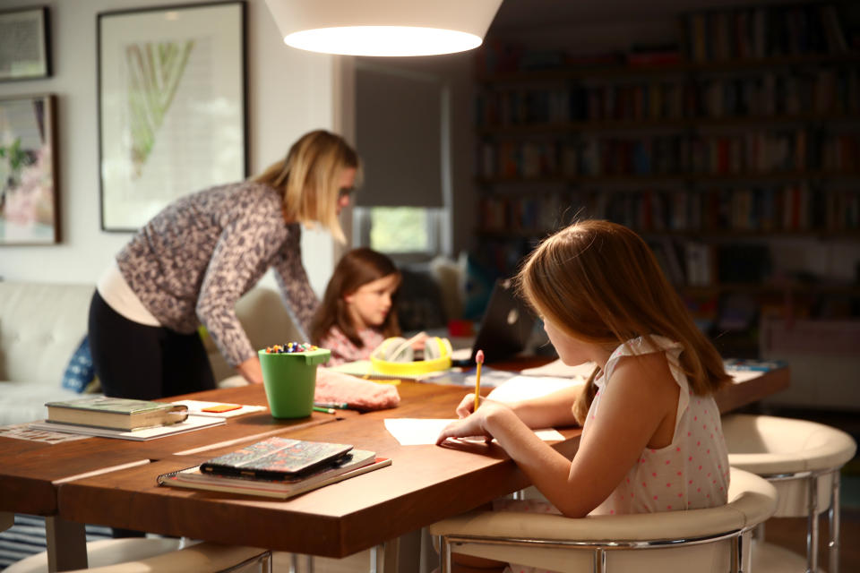 SAN ANSELMO, CALIFORNIA - MARCH 18:   Fourth grader Lucy Kramer (foreground) does schoolwork at her home, as her mother, Daisley, helps her younger sister Meg, who is in kindergarten, on March 18, 2020 in San Anselmo, California.  California Governor Gavin Newsom warned yesterday that because of coronavirus (COVID-19) schools are unlikely to reopen in the coming weeks and will more than likely remain closed until the summer break.  (Photo by Ezra Shaw/Getty Images)