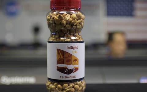 A specially created jar of InSight misson peanuts inside the Mission Control Area (MSA)  - Credit:  BILL INGALLS/AFP