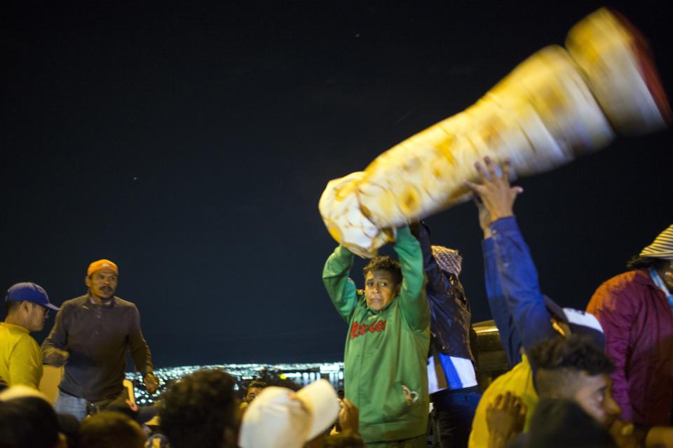 Volunteers prepare to donate blankets to Central American migrants at a temporary shelter in Queretaro, Mexico, Saturday, Nov. 10, 2018. Thousands of Central American migrants were back on the move toward the U.S. border Saturday, after dedicated Mexico City metro trains whisked them to the outskirts of the capital and drivers began offering rides north. (AP Photo/Rodrigo Abd)