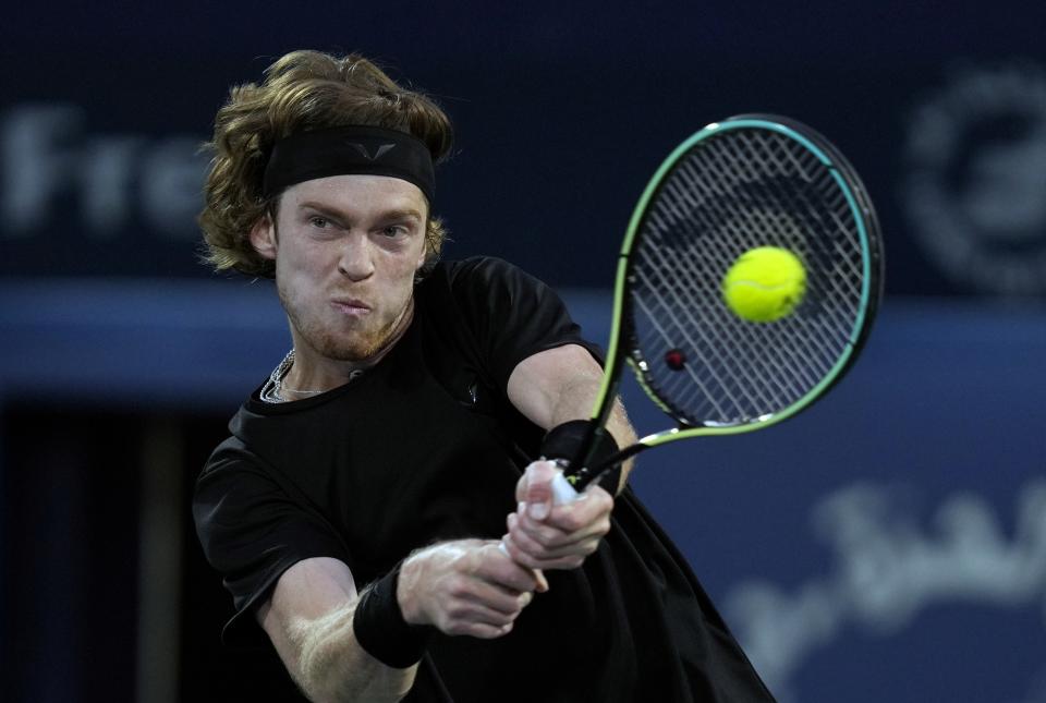 Andrey Rublev returns the ball to Germany's Alexander Zverev during their semi final match of the Dubai Duty Free Tennis Championships in Dubai, United Arab Emirates, Friday, March 3, 2023. (AP Photo/Kamran Jebreili)