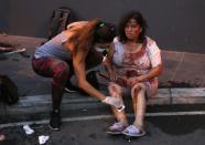 Wounded people wait to receive treatment outside a hospital following an explosion near the port in the Lebanese capital Beirut on August 4, 2020. - Two huge explosion rocked the Lebanese capital Beirut, wounding dozens of people, shaking buildings and sending huge plumes of smoke billowing into the sky. Lebanese media carried images of people trapped under rubble, some bloodied, after the massive explosions, the cause of which was not immediately known. (Photo by IBRAHIM AMRO / AFP) (Photo by IBRAHIM AMRO/AFP via Getty Images)