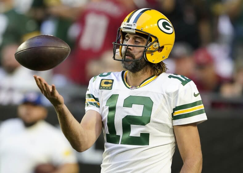 Green Bay Packers quarterback Aaron Rodgers (12) warms up prior to an NFL football game against the Arizona Cardinals, Thursday, Oct. 28, 2021, in Glendale, Ariz. (AP Photo/Darryl Webb)