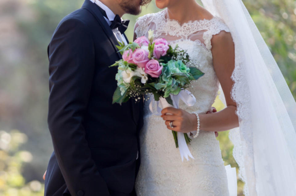 A couple pose for a romantic photo on their wedding day