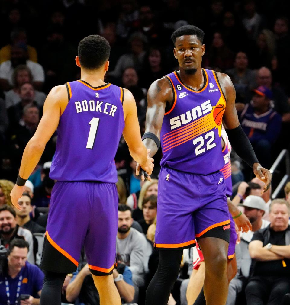 Nov 30, 2022; Phoenix, AZ, USA; Phoenix Suns guard Devin Booker (1) and center Deandre Ayton (22) teamed up for 81 points against the Chicago Bulls at Footprint Center.