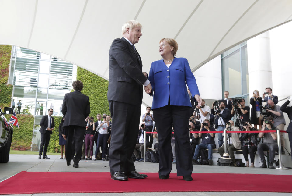 German Chancellor Angela Merkel welcomes Britain's Prime Minister Boris Johnson for a meeting at the Chancellery in Berlin, Germany, Wednesday, Aug. 21, 2019. (AP Photo/Michael Sohn)