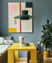 <p> A calming blue wall as backdrop allows vibrant, colorful furniture, lighting and graphic artwork to pop. Who wouldn&apos;t feel a little sunnier having breakfast at this joyful yellow table?&#xA0; </p> <p> Bench cushions are an ideal way to introduce pattern which softens the look and adds a touch of playfulness with a mix and match approach to different colors and designs. An oversize pendant shade in a deep green frames the space and a large indoor plant introduces an organic touch as well as tying in with the tone of the shade and green painted chairs.&#xA0; </p>