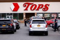 Police officers secure the scene after a shooting at TOPS supermarket in Buffalo