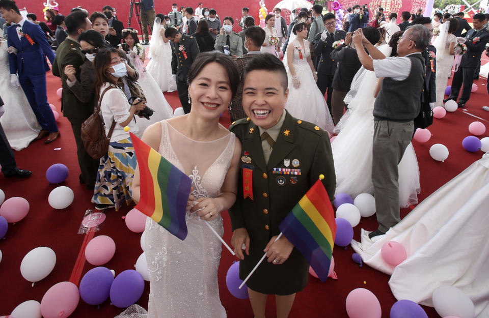 Lesbian couple Yi Wang, right, and Yumi Meng pose during a military mass weddings ceremony in Taoyuan city, northern Taiwan, Friday, Oct. 30, 2020. Two lesbian couples tied the knot in a mass ceremony held by Taiwan's military on Friday in a historic step for the island. Taiwan is the only place in Asia to have legalized gay marriage, passing legislation in this regard in May 2019.(AP Photo/Chiang Ying-ying)