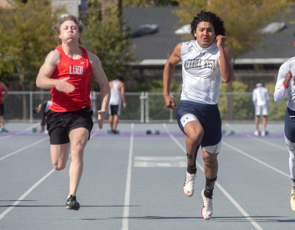 Lodi's Kaiden Merryman, left, and West's Yosef Poblano compete in the boys varsity 100 meters during a track meet at Tokay in Lodi on Thursday, Mar. 29, 2023. Athletes from Tokay, Lodi, St. Mary's and West high schools competed in the event. CLIFFORD OTO/THE STOCKTON RECORD