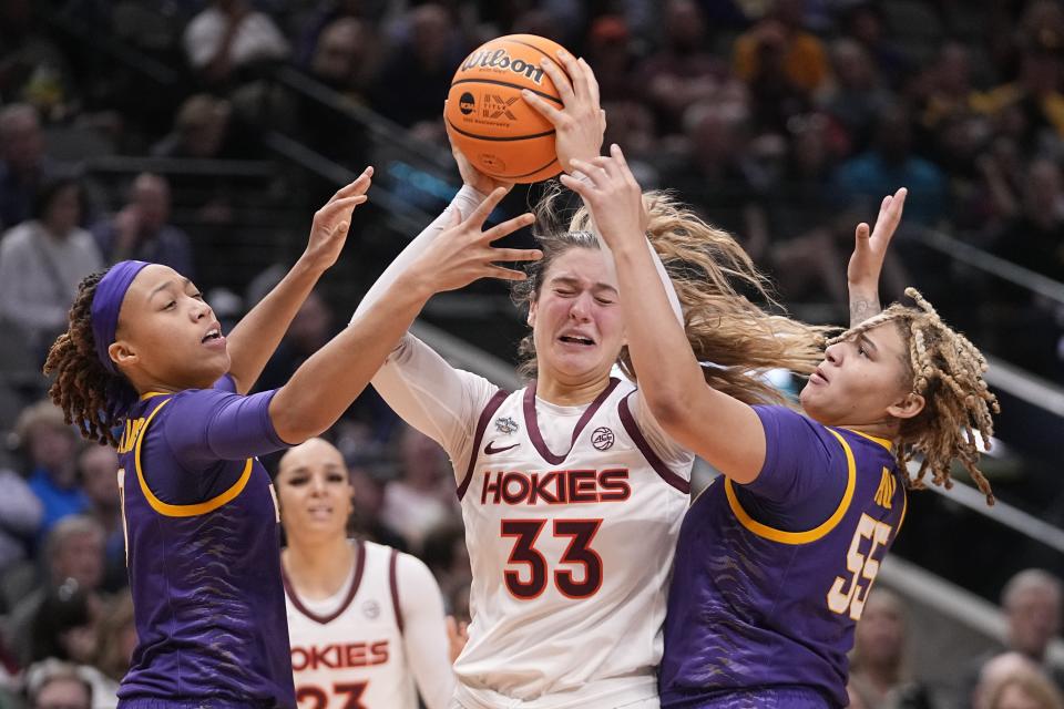 Virginia Tech's Elizabeth Kitley is trapped between LSU's LaDazhia Williams and Kateri Poole during the first half of an NCAA Women's Final Four semifinals basketball game Friday, March 31, 2023, in Dallas. (AP Photo/Darron Cummings)