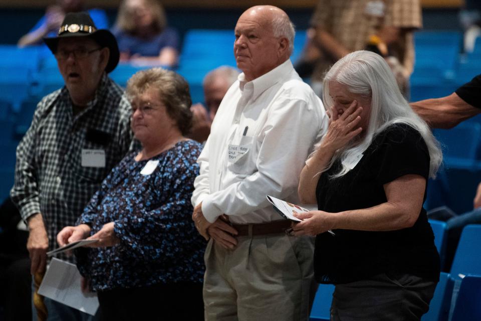 Relatives of Pfc. Charles Reed, a 1965 graduate who died in the Vietnam War in 1967, stand during the monument unveiling.