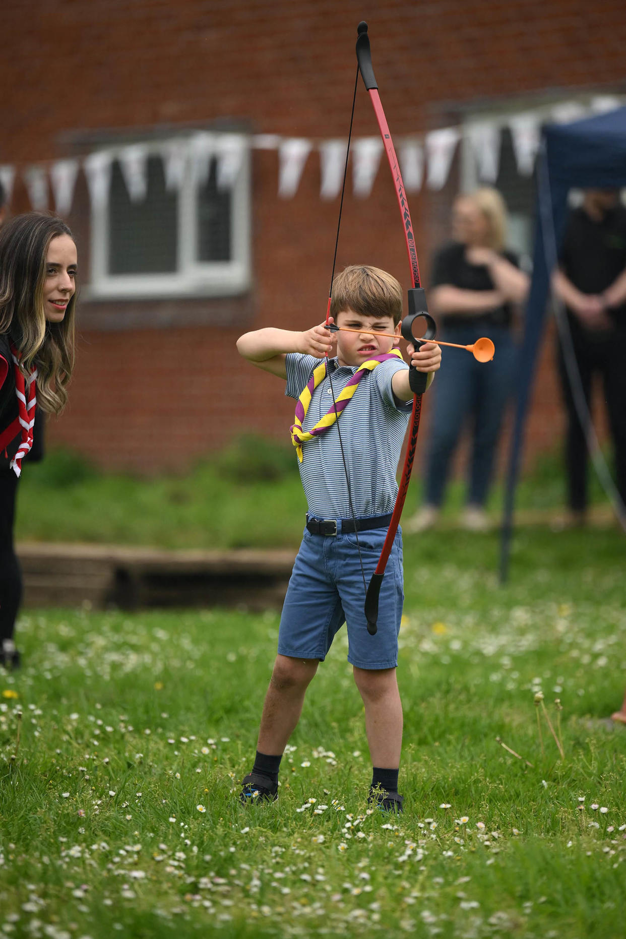 Prince Louis of Wales tries his hand at archery while taking part in the Big Help Out, during a visit to the 3rd Upton Scouts Hut in Slough, west of London on May 8, 2023, where the family joined volunteers helping to renovate and improve the building.  (Daniel Leal  / AFP via Getty Images)