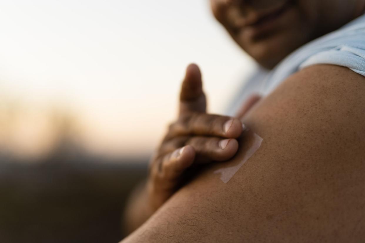Man putting nicotine patch on his arm