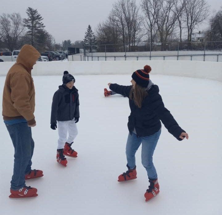 Matt Kratz, left, Jacob Kratz and Melissa Kratz, all of Massillon, take to the ice Tuesday morning at the Massillon City Ice Skating Rink. The ice center opened Tuesday to the public and is free to use.