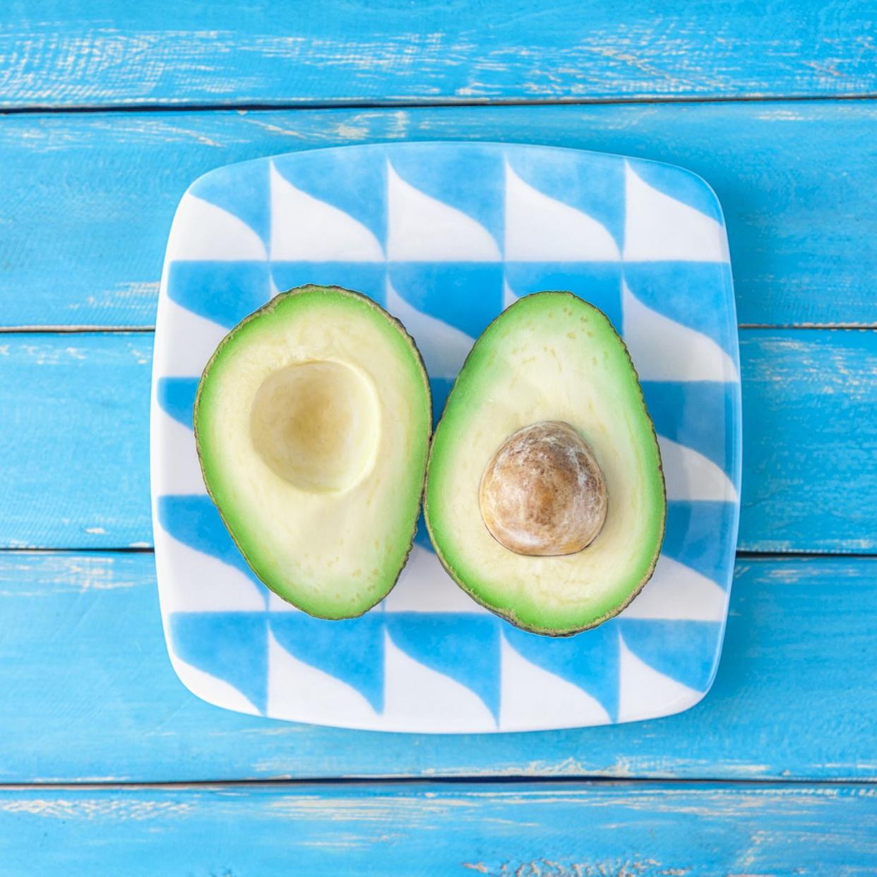 Elevated view of a fruit on a plate. Blue wooden background.