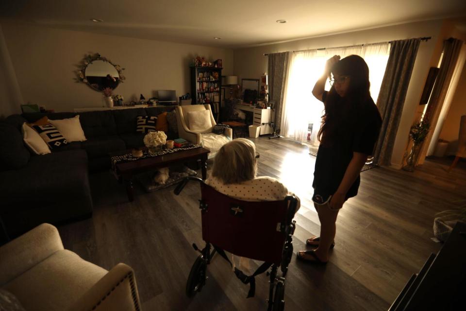 Rosa Angelica Saldana is asked by her granddaughter, Paola Rojas, if she can bring her something to eat or drink.