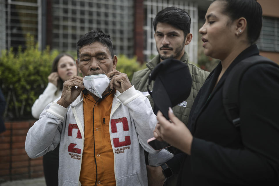 Narciso Mucutuy, the grandfather of the 4 rescued Indigenous children, puts on his mask after speaking to the media from the entrance of the military hospital where the children who survived an Amazon plane crash that killed three adults and then braved the jungle for 40 days before being found alive, are receiving medical attention, in Bogota, Colombia, Sunday, June 11, 2023. (AP Photo/Ivan Valencia)