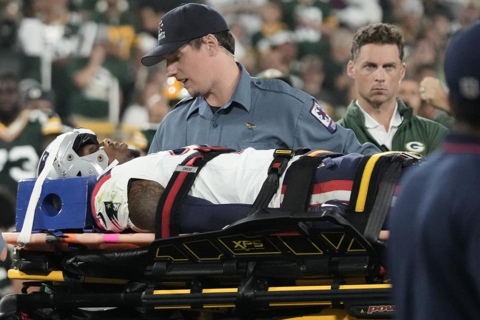 New England Patriots cornerback Isaiah Bolden is brought off the field after being injured during the second half of the team's preseason NFL football game against the Green Bay Packers, Saturday, Aug. 19, 2023, in Green Bay, Wis. The game was suspended. (AP Photo/Morry Gash)