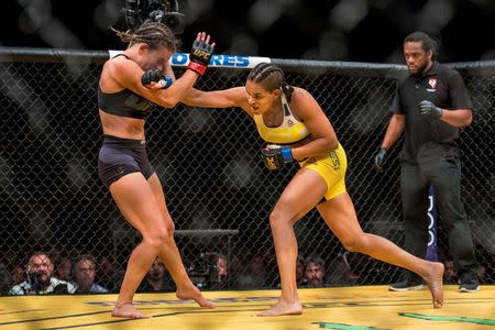 Jul 9, 2016; Las Vegas, NV, USA; Amanda Nunes (blue gloves) punches Miesha Tate (red gloves) during UFC 200 at T-Mobile Arena. Nunez won by rear naked choke. Mandatory Credit: Joshua Dahl-USA TODAY Sports