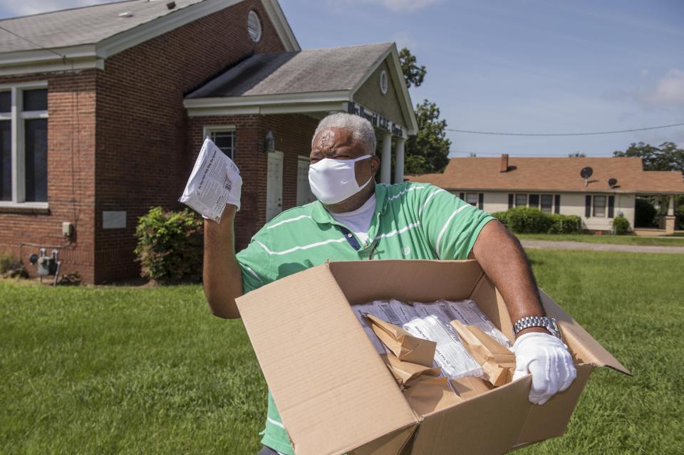 Rev. Larry Fryer holds a box of masks near Miles Memorial C.M.E. Church, not far from where he plans to give them away.  Photographed in Augusta, Ga., Thursday morning August 26, 2020.