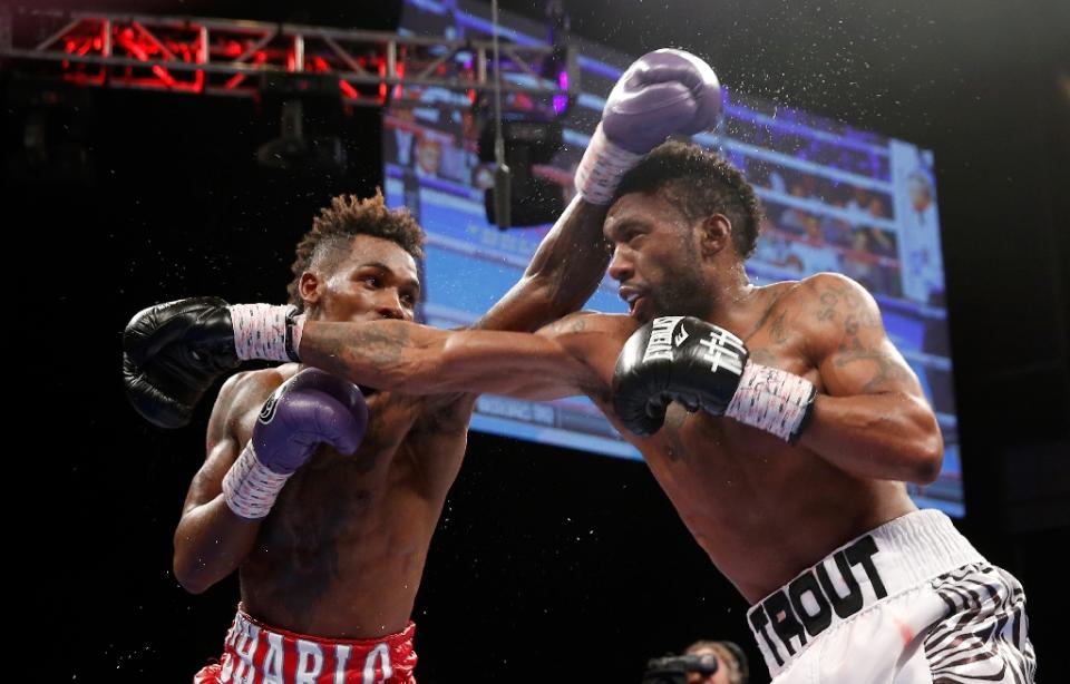 Austin Trout (R) trades punches with Jermall Charlo during their May 2016 bout. (AFP Photo/Steve Marcus)