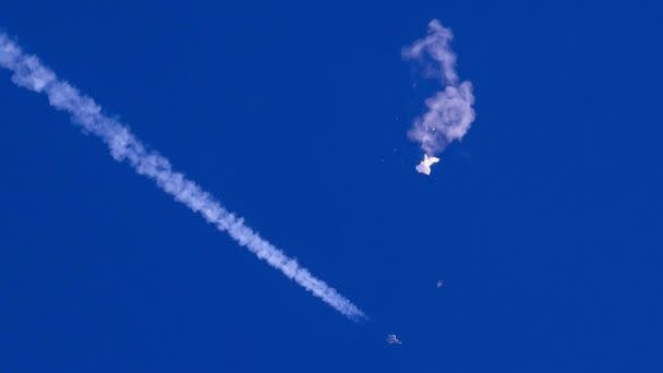 PHOTO: A fighter jet flies past the remnants of a large balloon after it was shot down above the Atlantic Ocean, just off the coast of South Carolina near Myrtle Beach, Feb. 4, 2023. (Chad Fish/AP, FILE)